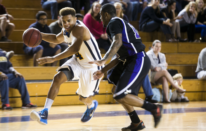 Sophomore guard Jonathan Terry dribbles around an opponent. This week, Terry was named the University Athletic Association (UAA) Men’s Basketball Co-Player of the Week | Courtesy of Emory Athletics