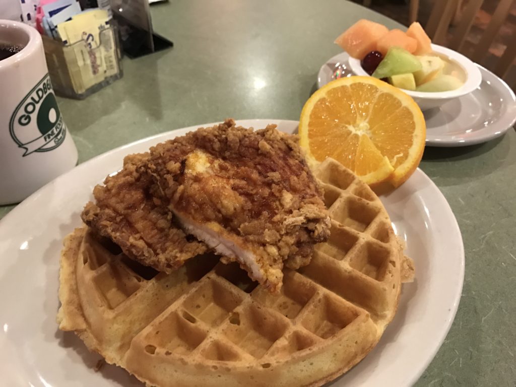 Goldberg's fried chicken and waffle platter is unlike the New York style food often found at Delis like this one and consists of golden brown waffle topped with a piece of crispy fried chicken and a light syrup drizzle.